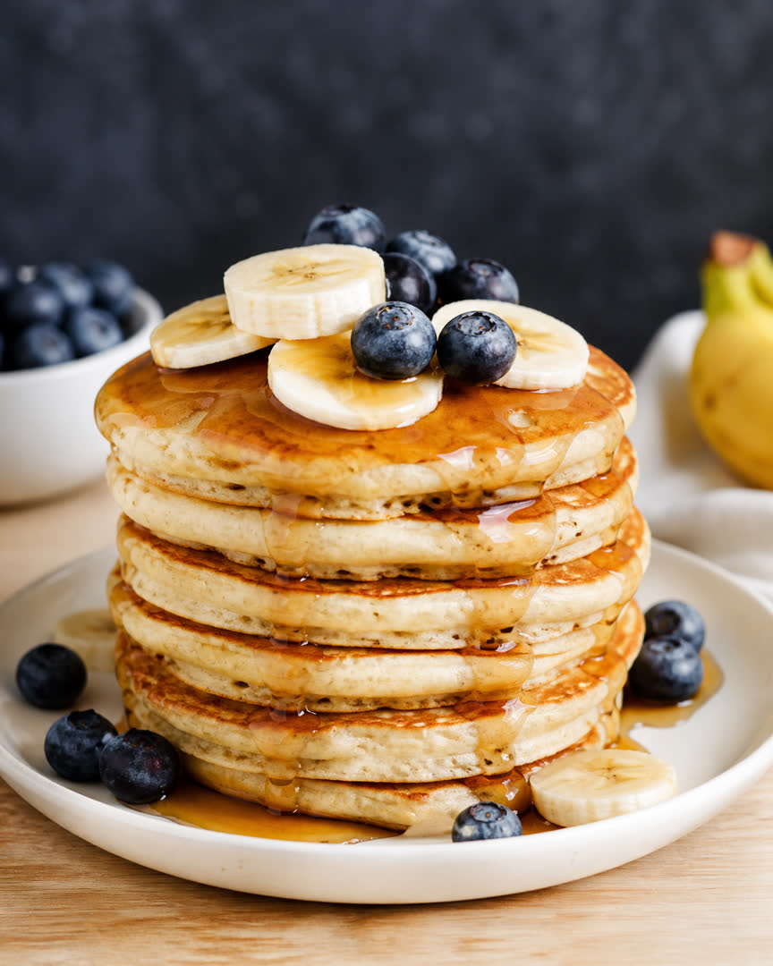 Délicieux pancakes à la banane avec sirop d'érable et fruits frais